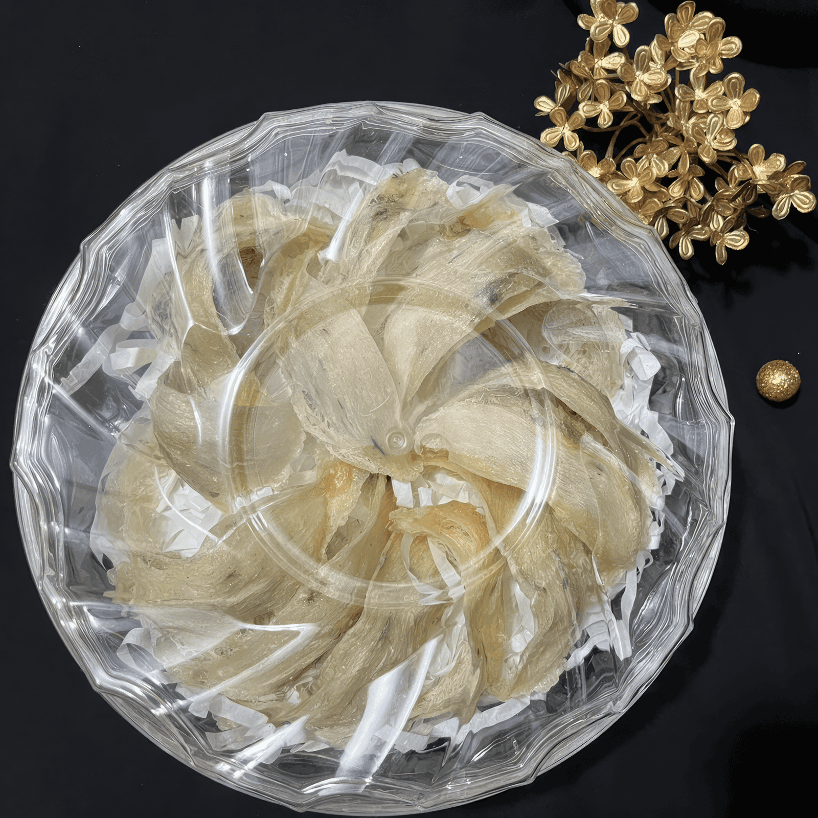 Picture of Yến Thô laying in a basket next to gold flowers